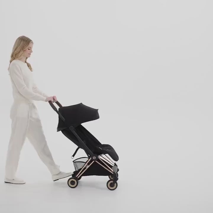 Lifestyle image of the Cybex Platinum Coya 2 Stroller - Style Collection cybex coya 2 style collection one-hand fold video demonstration.