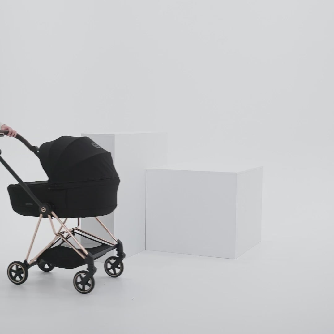 CYBEX Mios 5 folding with the Fold Lux Carry Cot attached