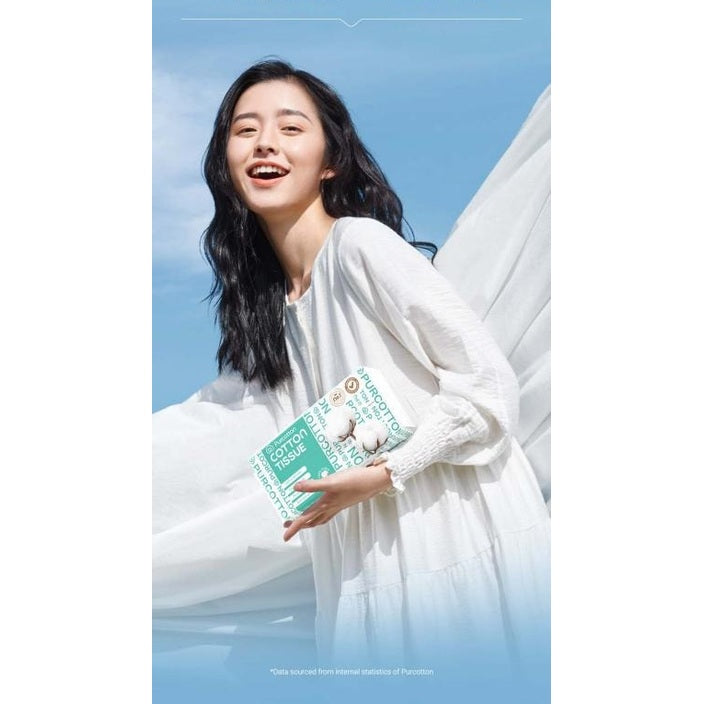 PurCotton Cotton Tissues 3-pack box (100 sheets) with turquoise packaging held by smiling woman in white dress