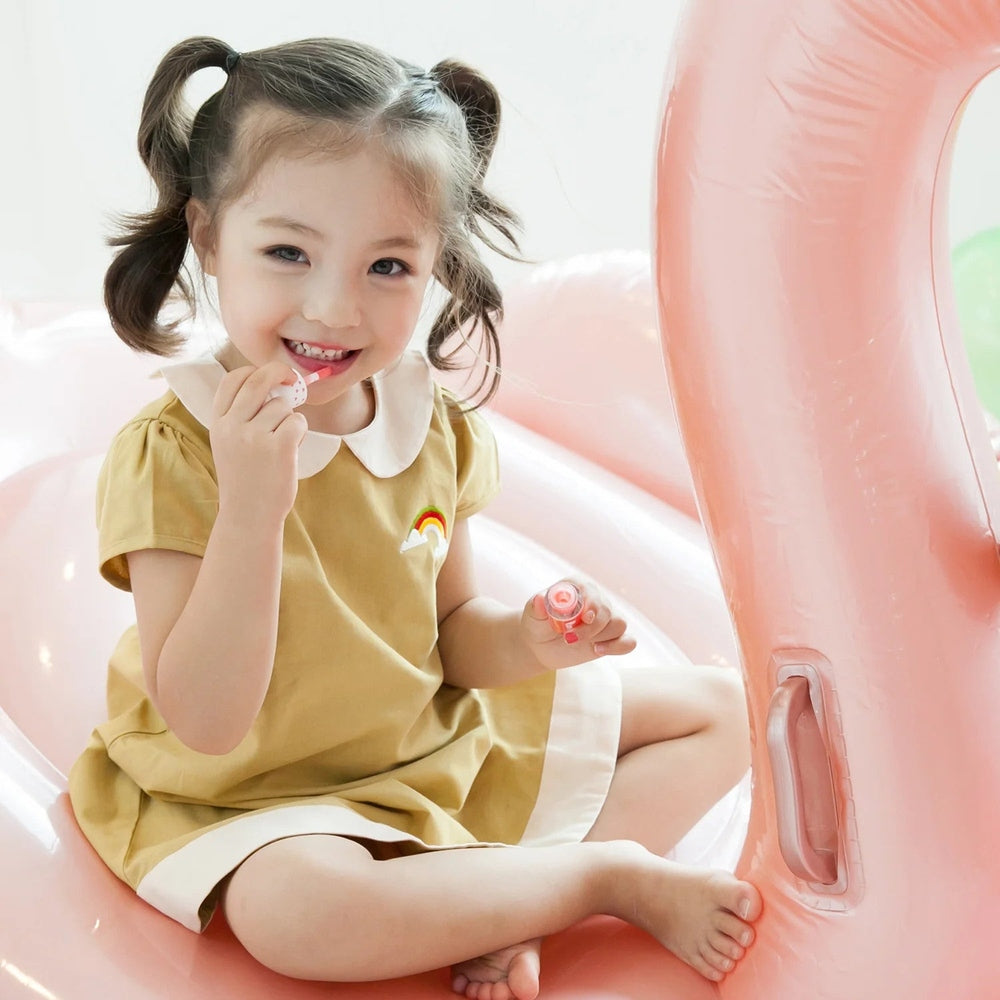 Puttisu Juicy Lip Gloss #02 Pink Bubblegum by PUTTISU; pink lip gloss in a child's hand