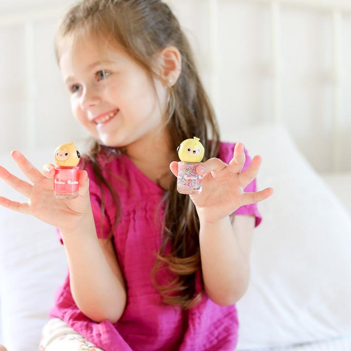 Puttisu Pangpang Nail Polish Color C14 My Love Bear; two pink glitter bottles held by a smiling girl