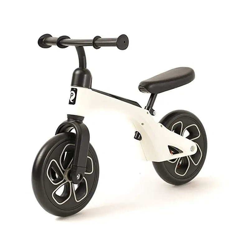 QPLAY Balance Bike for kids, white frame, black 12-inch wheels, padded saddle; child sits and glides.