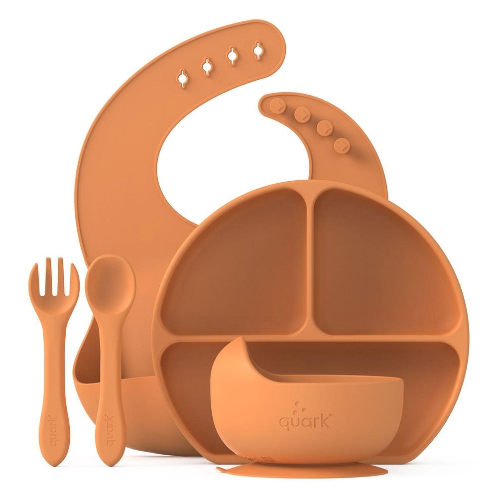 Quark Feedi 5-piece silicone baby feeding set in orange with divided plate, bowl, spoon, fork and bib