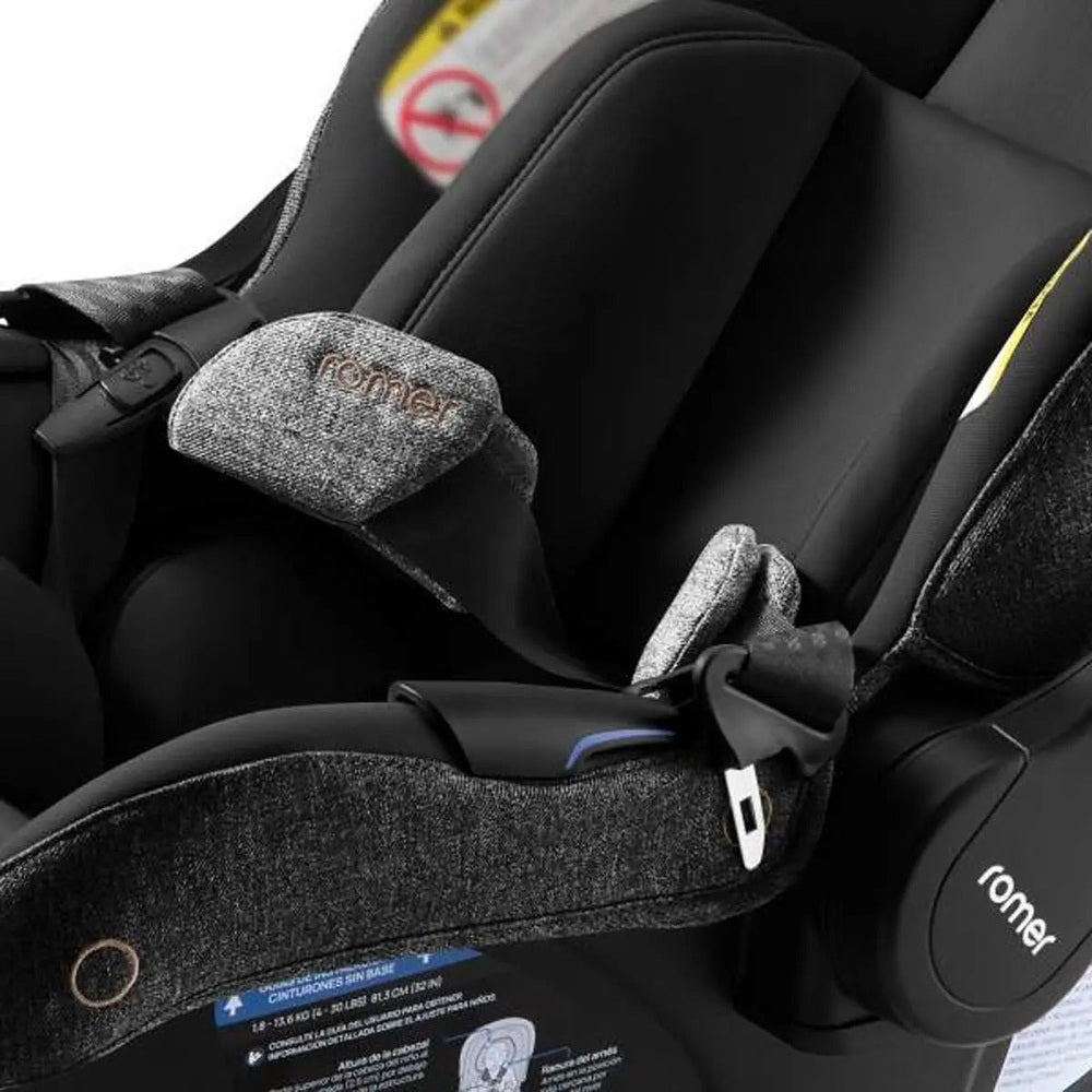 Romer Juni Infant Car Seat with Versa Base in charcoal fabric; showing the secure 5-point harness fastened.