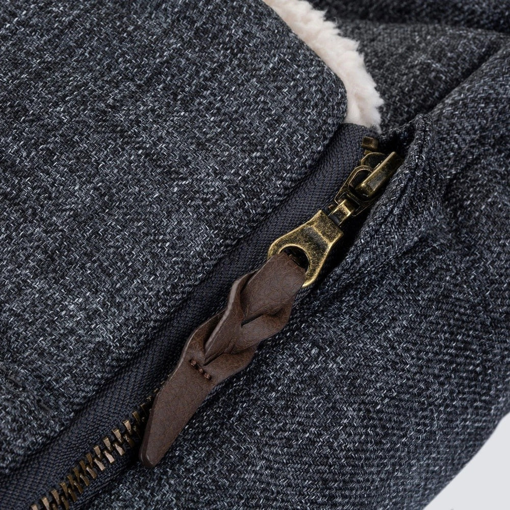 Romer Juni Winter Cover stroller footmuff in dark heather gray, brass zipper with brown leather pull, plush lining visible.