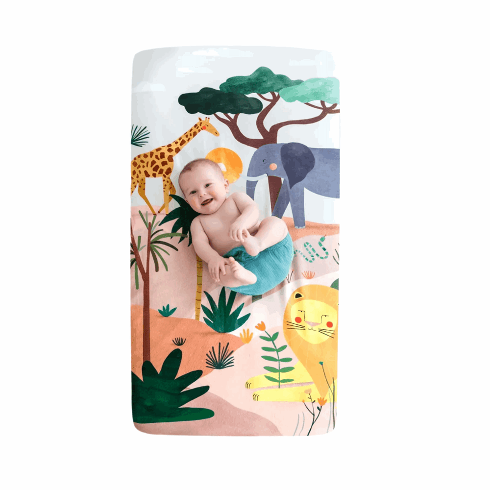 Rookie Humans cotton sateen crib sheet Savanna print with a baby among safari animals (giraffe, elephant, lion)