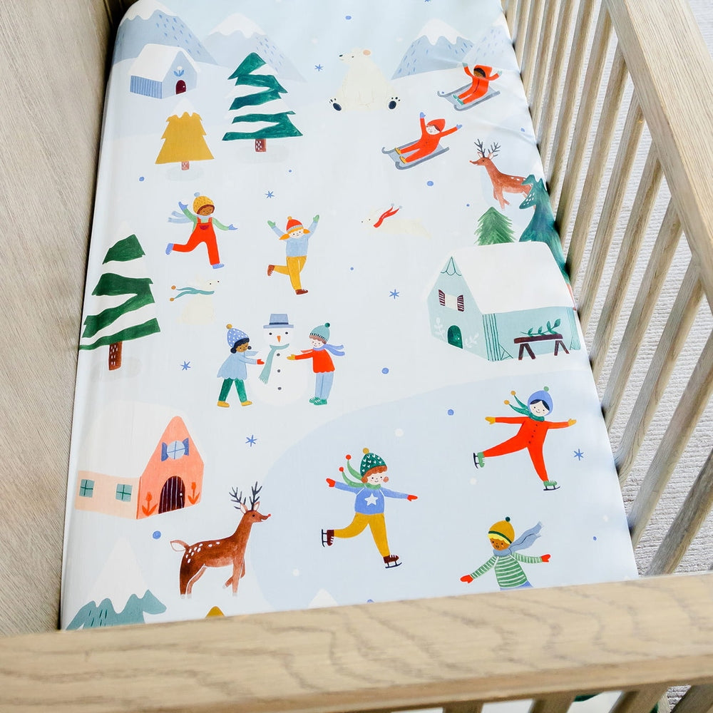Rookie Humans cotton sateen crib sheet Snowy Day with kids skating, snowmen, deer and houses