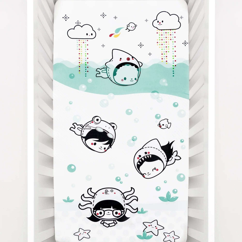 Rookie Humans Organic Cotton Sateen Crib Sheet Dive In featuring aqua sharks and bubbles on a white background