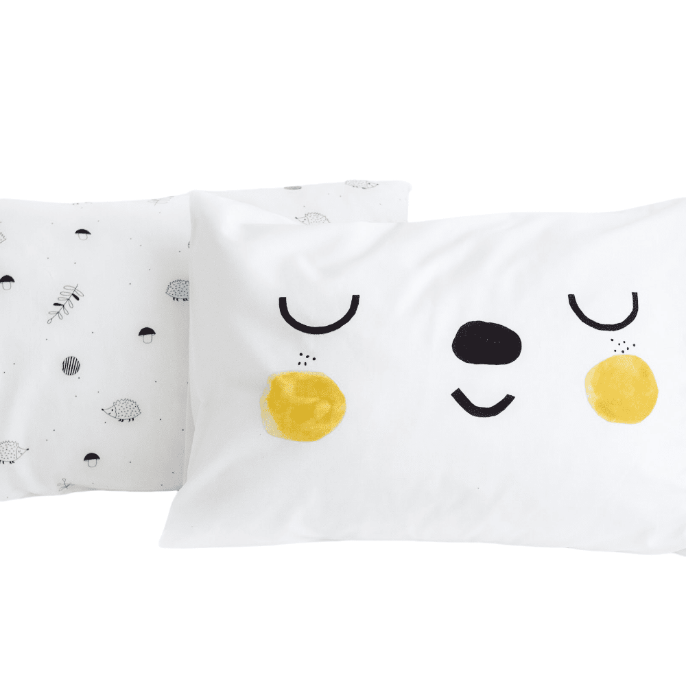 Rookie Humans 2-pack pillowcases featuring a bear-face woodland print on white fabric with yellow cheeks