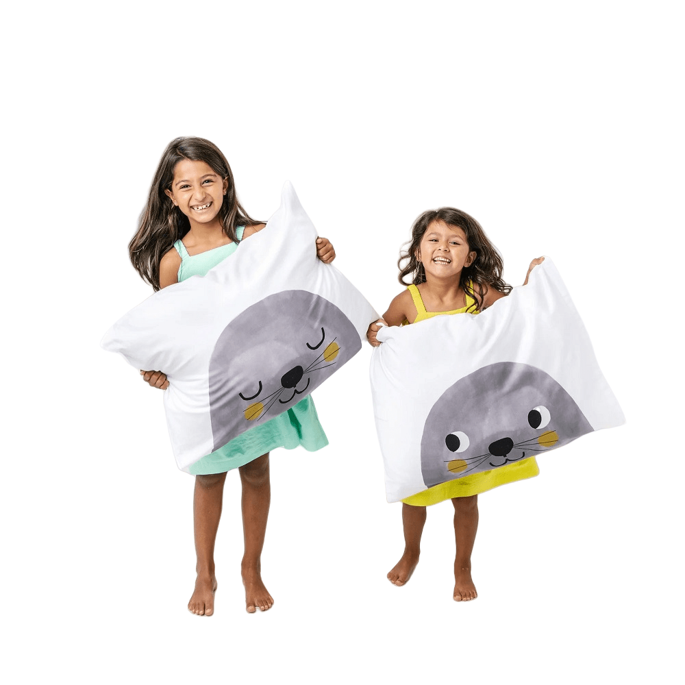 Rookie Humans toddler pillowcases 2-pack Underwater Love; white cases with gray seal graphic, shown with two smiling kids.