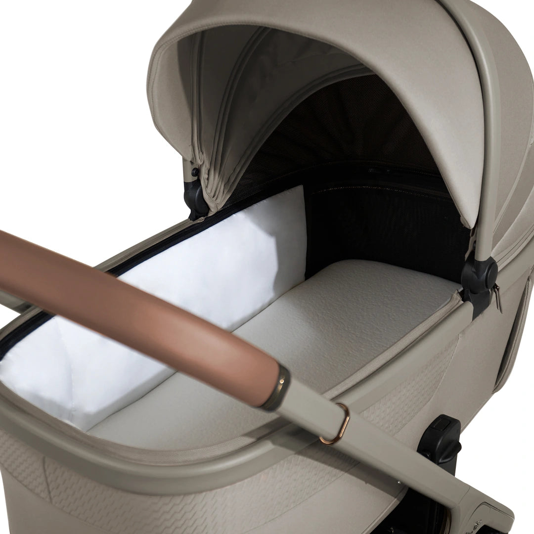 Interior of the Champagne Cove 2 bassinet showing the mattress and side lining.
