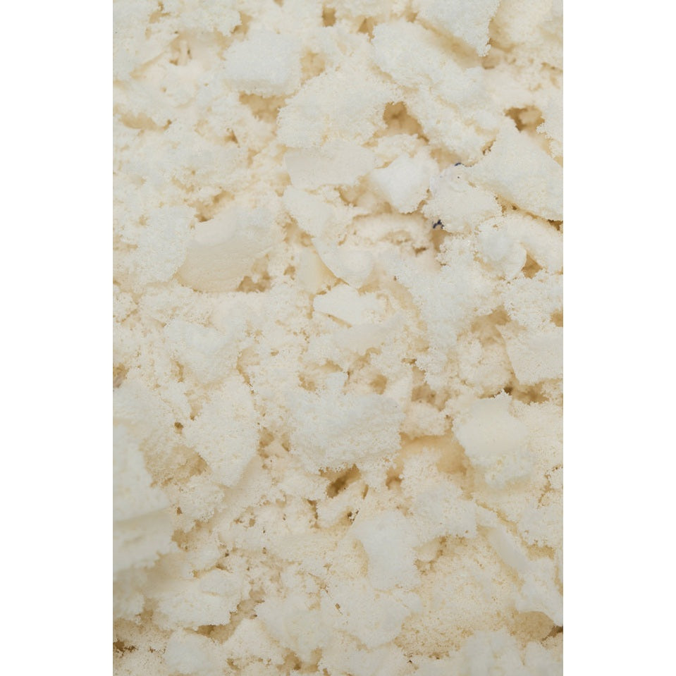 Sleeptek shredded rubber baby pillow filling in off-white crumbly chunks