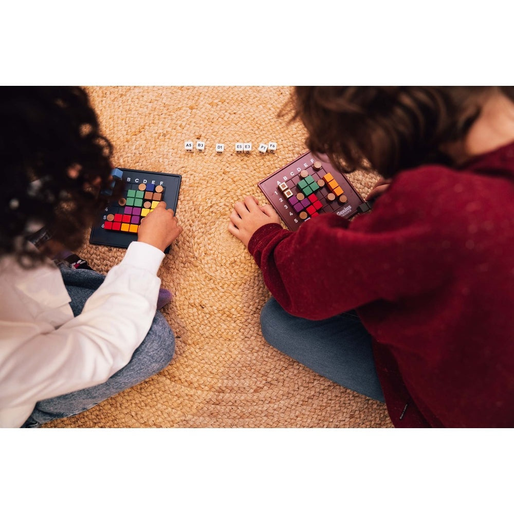 Smart Games Genius Square educational toy on blue game board with colorful cubes; kids playing on a beige carpet