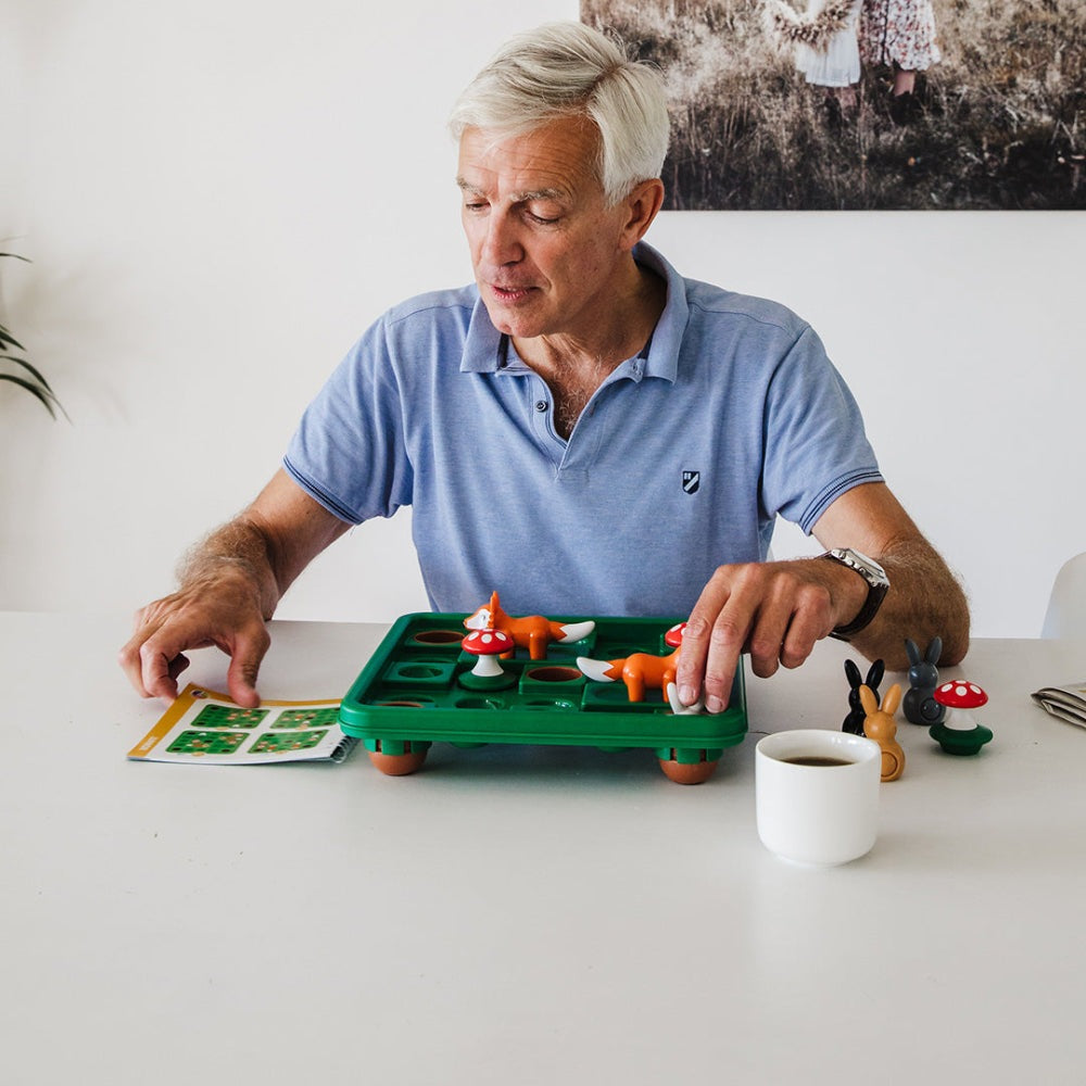 Jump In XXL puzzle game by SMART GAMES, green tray with colorful animal pieces and mushrooms