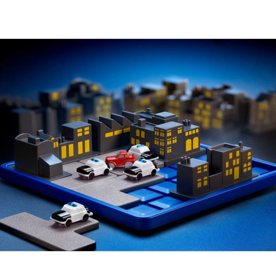 Smart Games Roadblock city puzzle set on a blue base with gray buildings and several white police cars