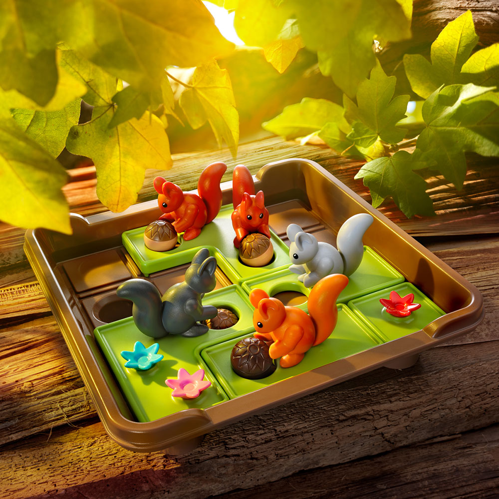 Smart Games Squirrels Go Nuts XXL puzzle game with four colored squirrels on green tiles