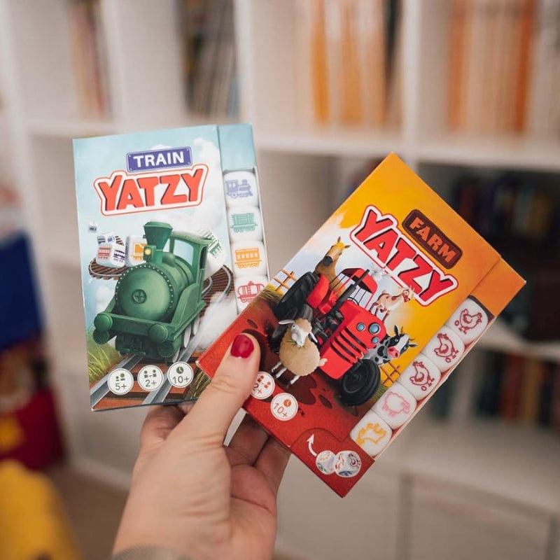 Smart Games Train Yatzy and Farm Yatzy boxes featuring colorful train and tractor designs; set of 2