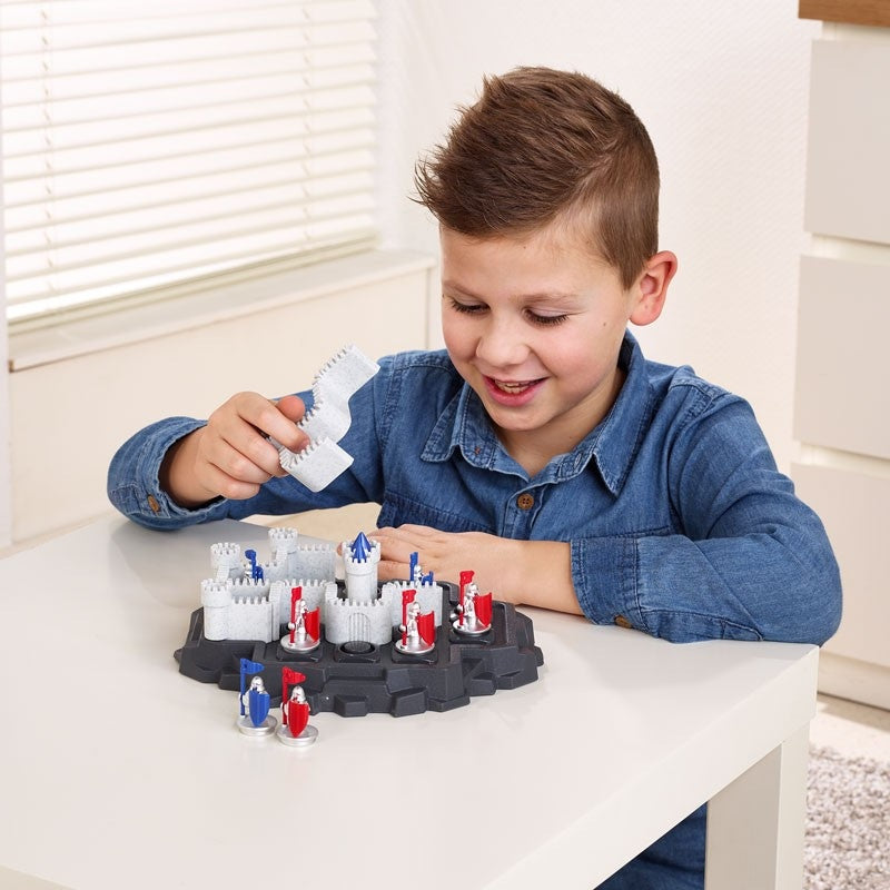 Smart Games Walls & Warriors puzzle game; grey castle towers with red and blue knights on black base, child playing