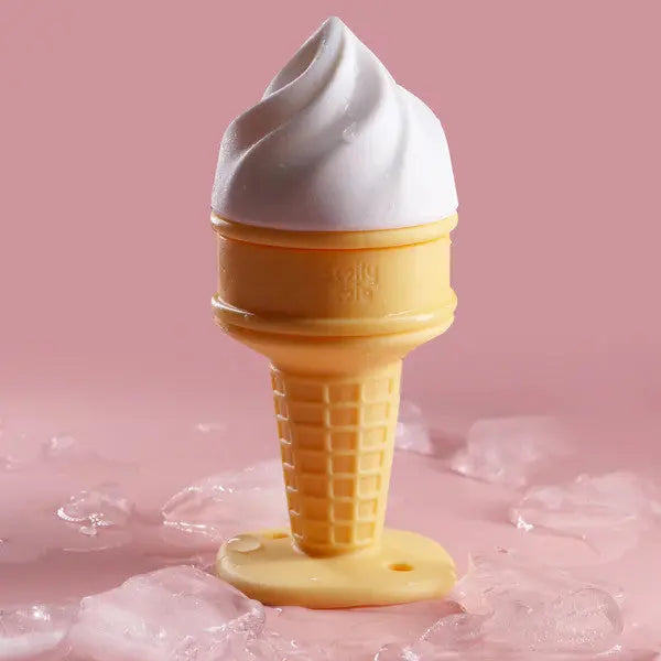 Smily Mia & Dommy Ice Cream Freezable Teether in a yellow cone with white swirl, shown standing upright on pink background.