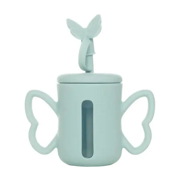 Smily Mia & Dommy Silicone Straw Bottle in light blue with winged handles and butterfly lid, showing liquid level through the window.