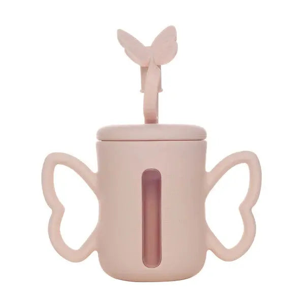 Smily Mia & Dommy silicone straw bottle in pink with butterfly-shaped handles held for easy grip.