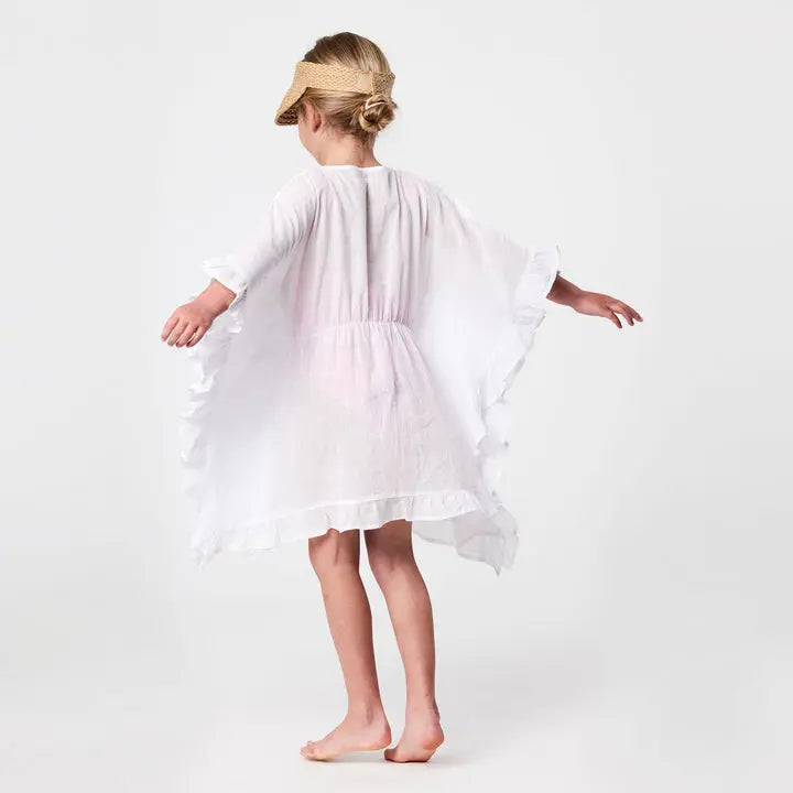 Snapper Rock White Frilled Cover Up for kids, airy white swimwear with flutter sleeves, girl twirling.