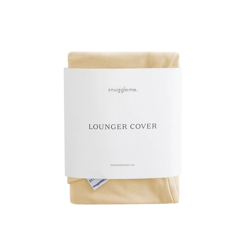 Snuggle Me Organic Infant Lounger Cover in beige natural fabric, neatly folded with white label band.