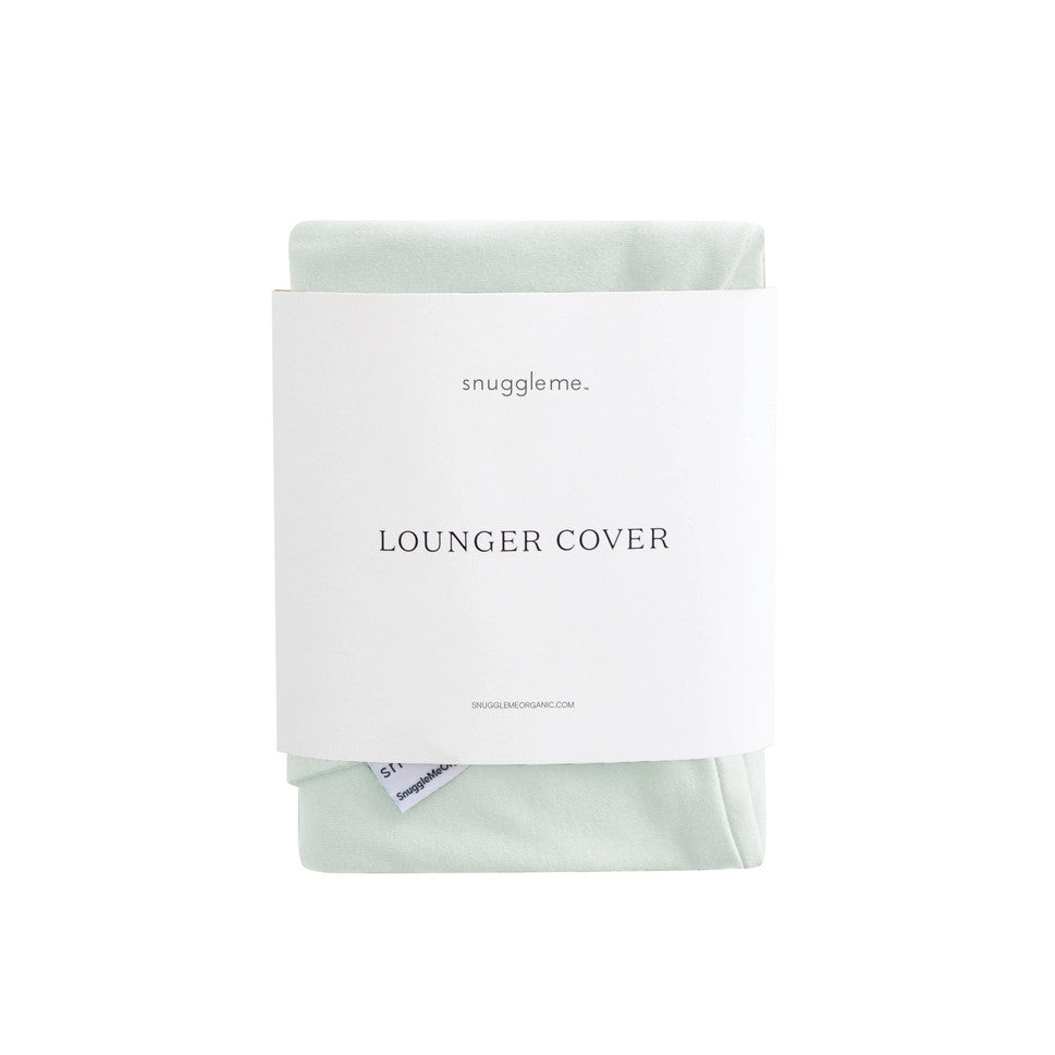 Snuggle Me Organic Infant Lounger Cover in mint green fabric, shown folded with brand label.