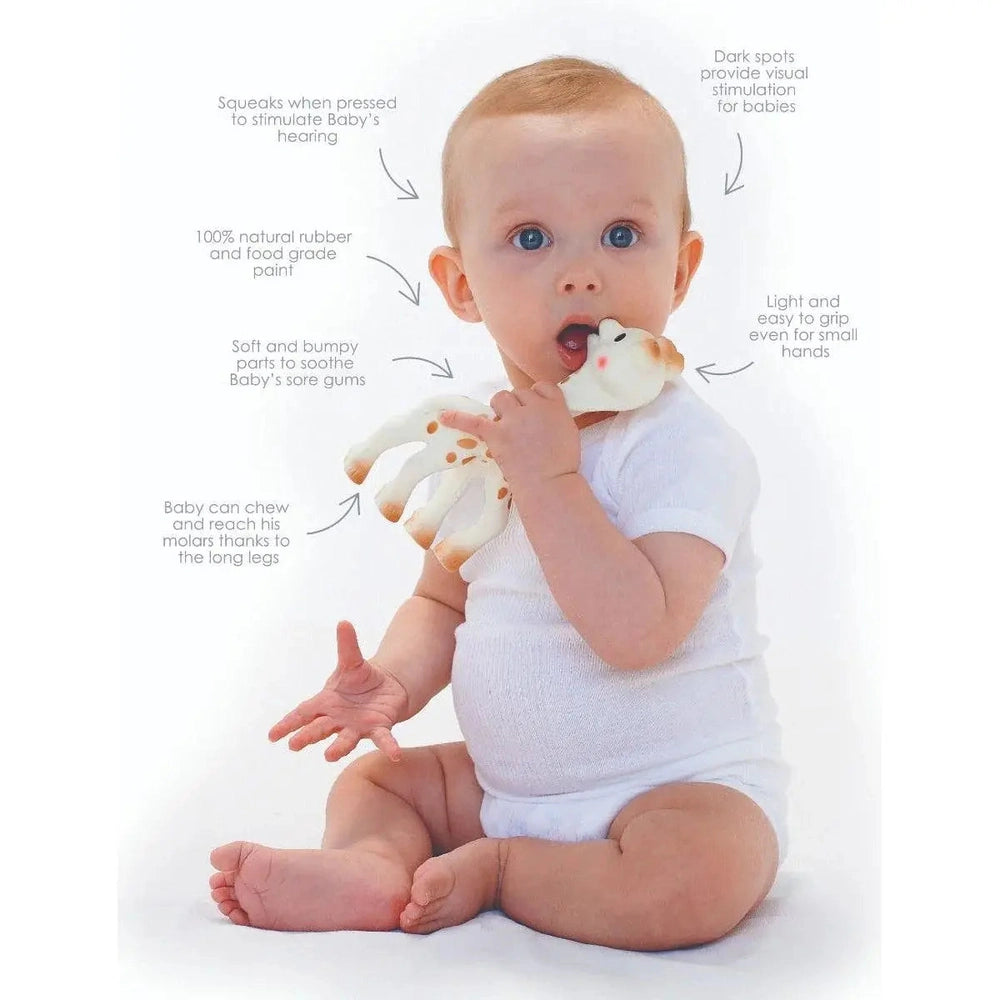 Sophie La Girafe teether, natural rubber baby toy with soft chewable limbs, held by a baby