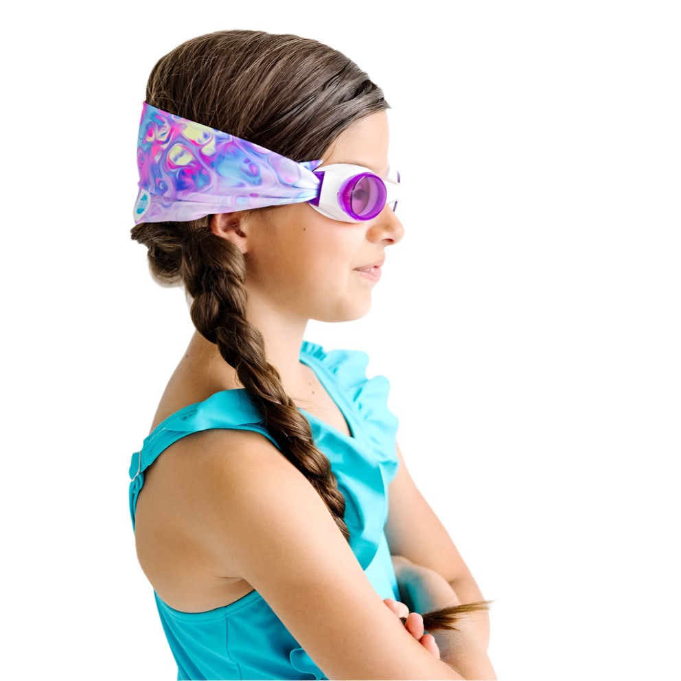 Splash Swim Goggles Pastel Swirl, purple lenses, worn by a girl in a turquoise swimsuit