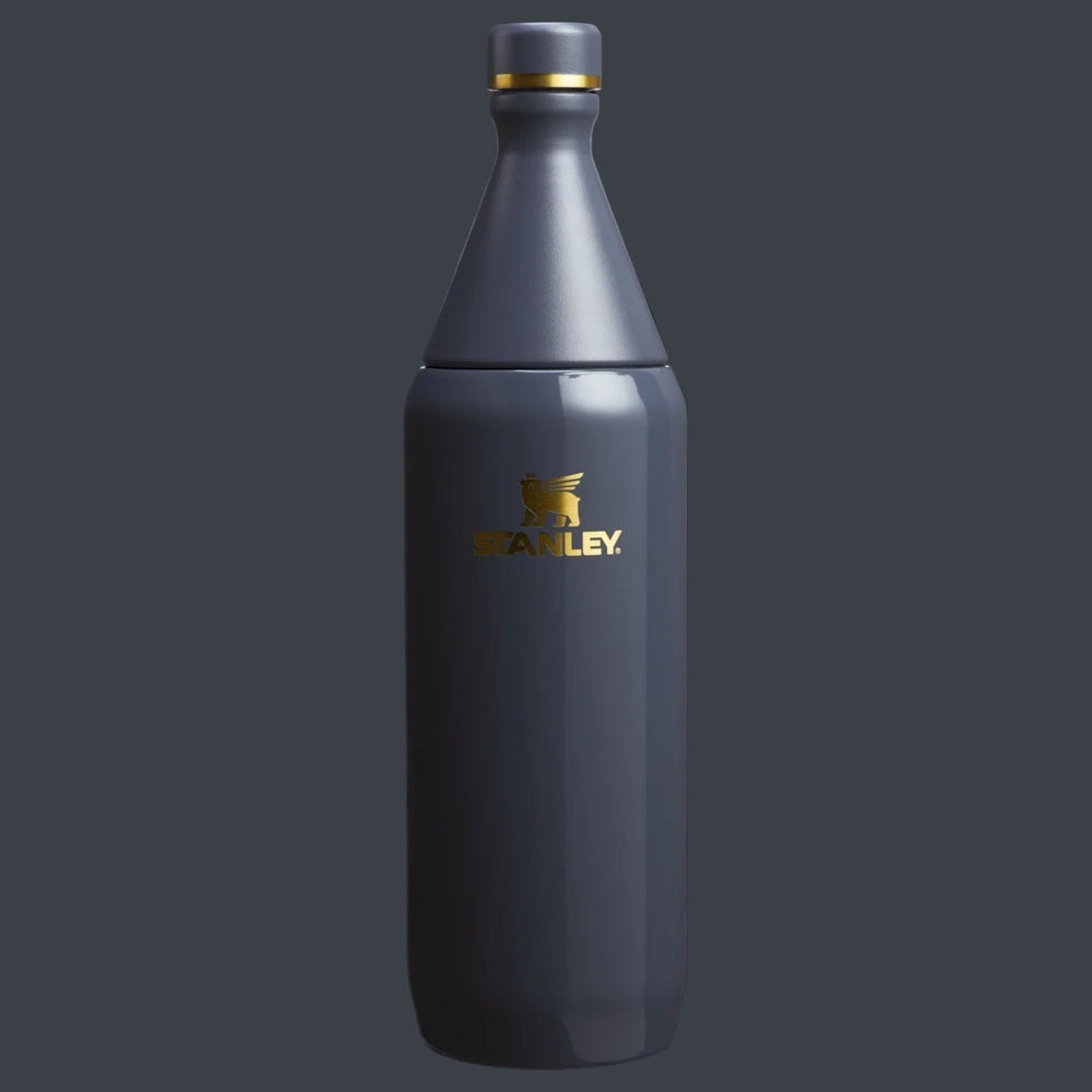 Stanley All Day Slim Bottle 20 oz in gray with gold logo, standing upright to show sleek, easy-grip design.