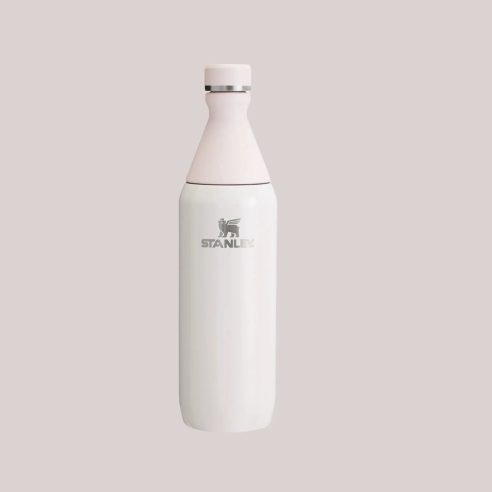 Stanley All Day Slim Bottle 20 oz, white stainless steel with pink cap, standing upright.