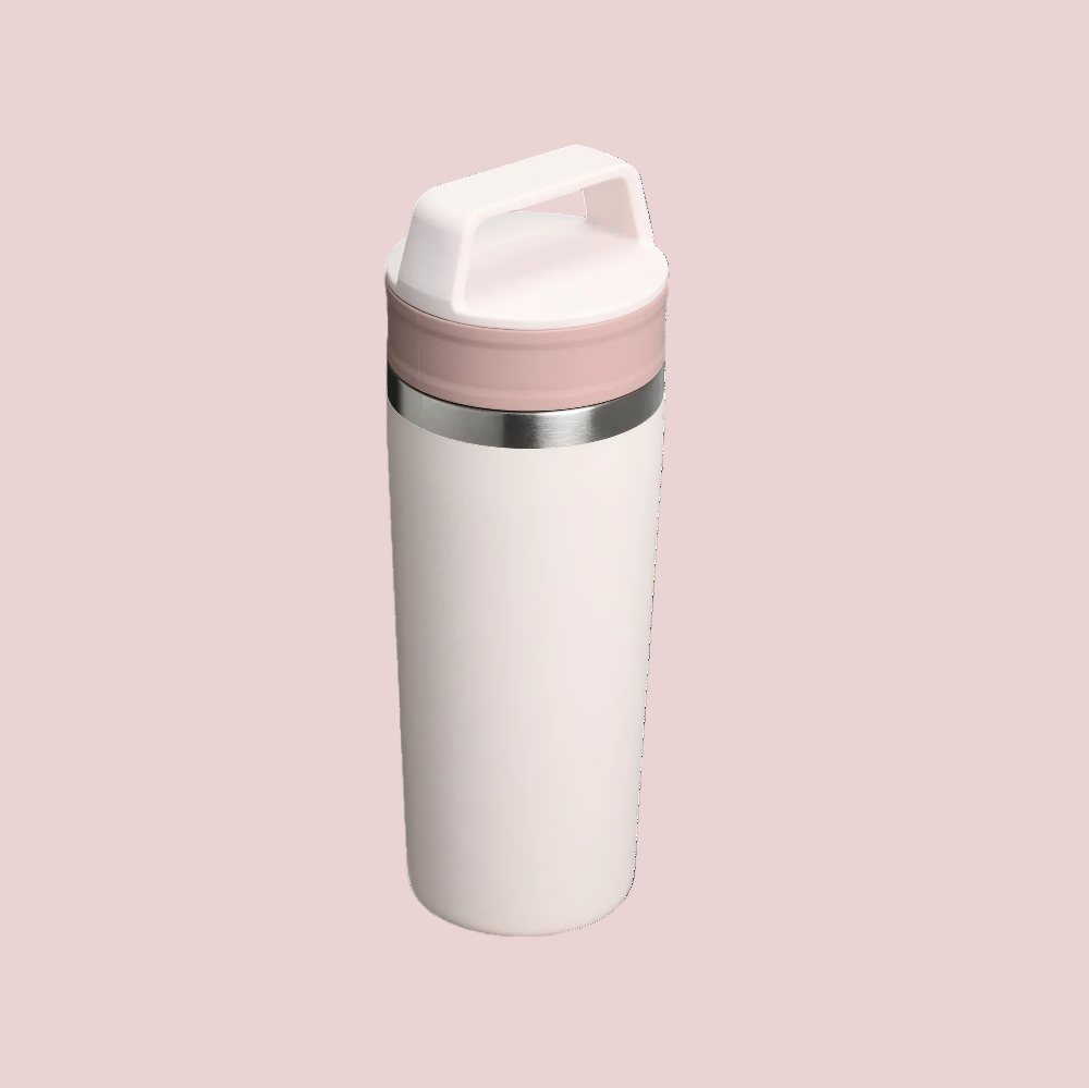 Stanley Cafe-To-Go Travel Mug 16 oz in white with pink lid and stainless band, standing upright.