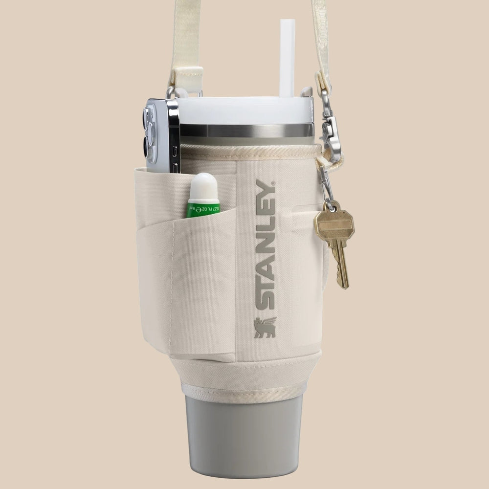 Stanley All Day Quencher Carry-All 30 oz bottle in beige sleeve with strap and keys