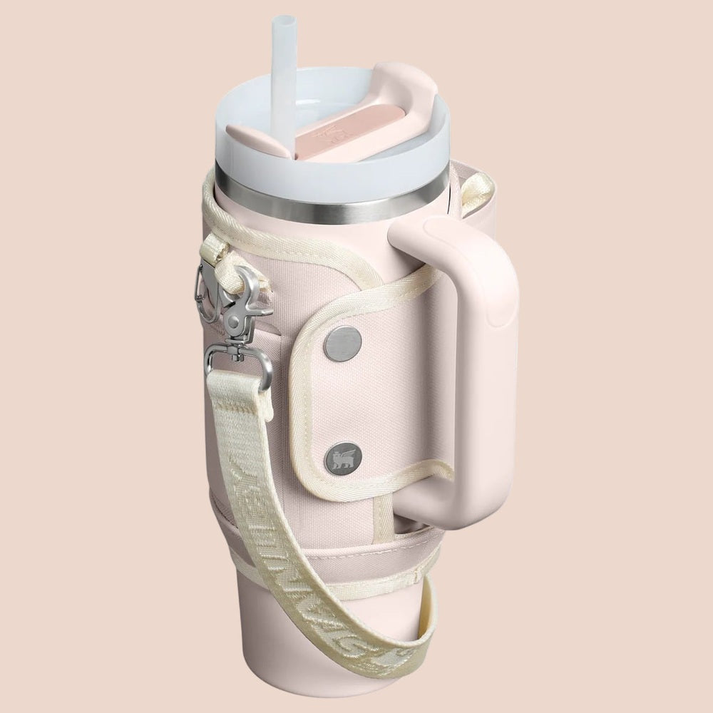 Stanley All Day Quencher Carry-All 30 oz water bottle in pale pink with cream strap and lid clip