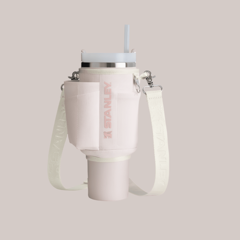 Stanley All Day Quencher Carry-All 40 oz water bottle in soft pink with cream detachable strap