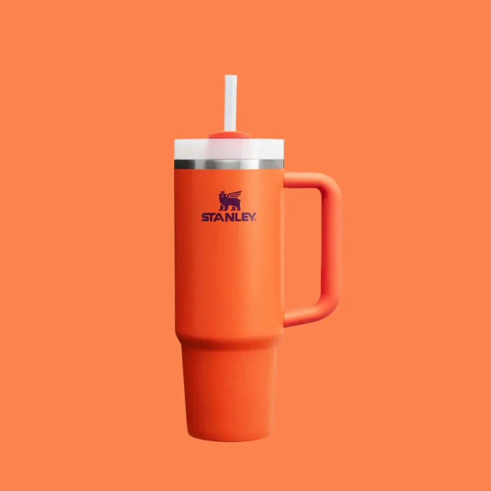 Stanley The Quencher H2.0 Flowstate Tumbler 30 oz orange with white lid and straw, standing upright.