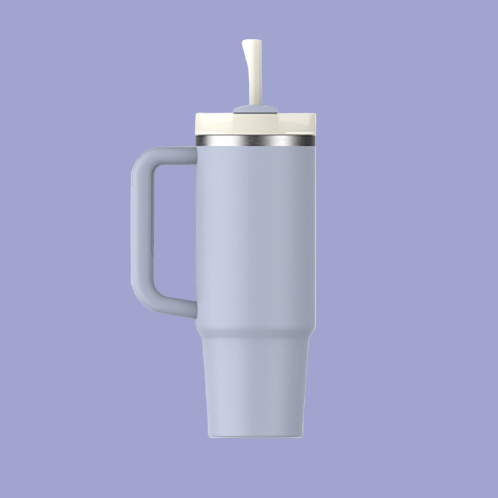 Stanley The Quencher H2.0 Flowstate 30 oz tumbler in light blue with white lid, handle held for easy carrying.