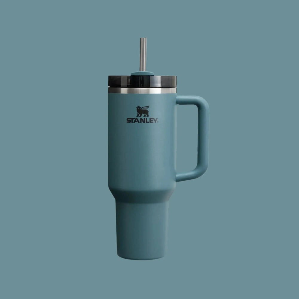 Stanley The Quencher H2.0 Flowstate 40 oz tumbler in teal with stainless lid and straw, handle for easy sipping.