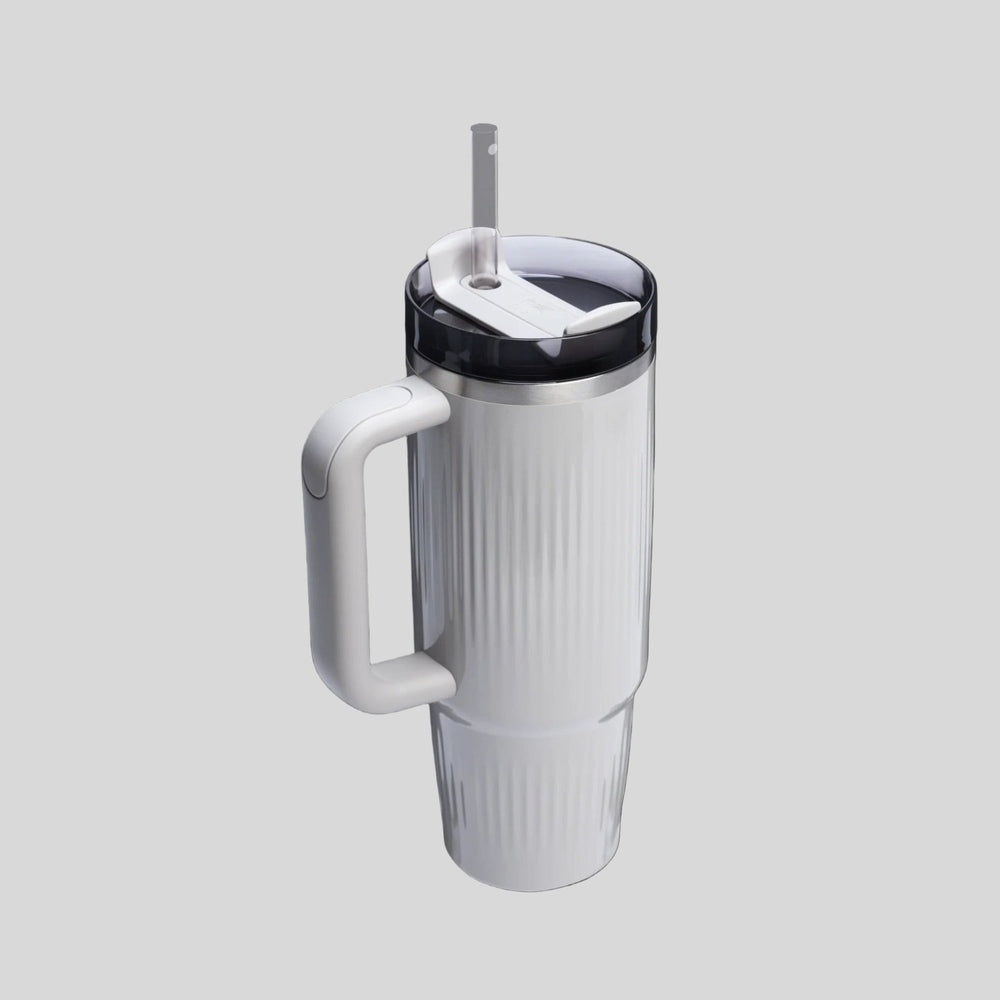 STANLEY The Quencher H2.0 Fluted Tumbler 30 oz, white with handle and straw, demonstrating easy sipping.