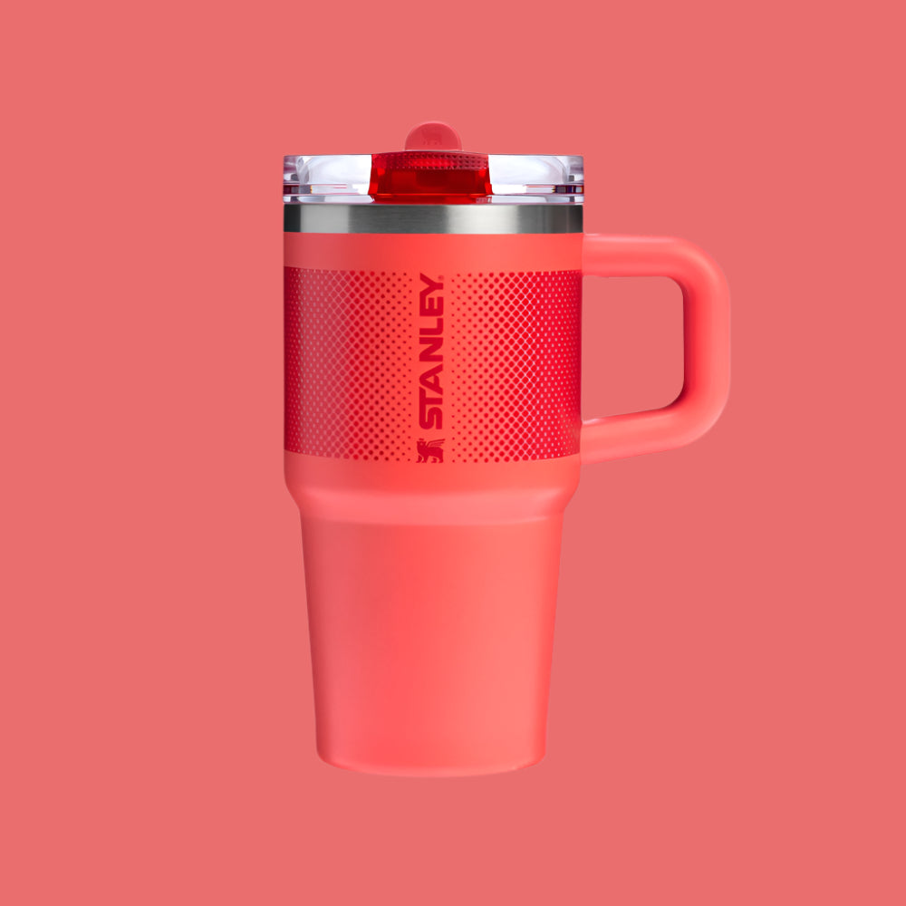 Stanley Quencher ProTour Flip Straw Tumbler 20 oz in coral pink, with flip straw lid and sturdy handle.