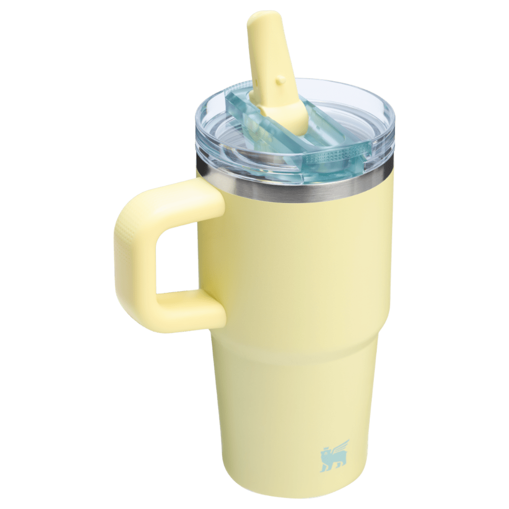 Stanley The Quencher Protour Flip Straw Tumbler 20 oz in pale yellow with clear lid, flip-straw raised for sipping.