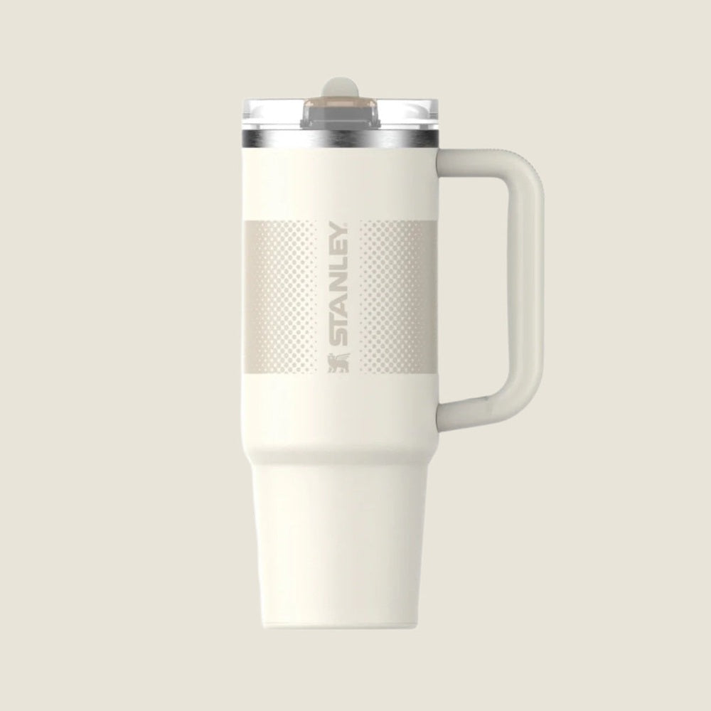 Stanley The Quencher Protour Flip Straw Tumbler 30 oz in white with textured grip and upright handle, flip lid visible.