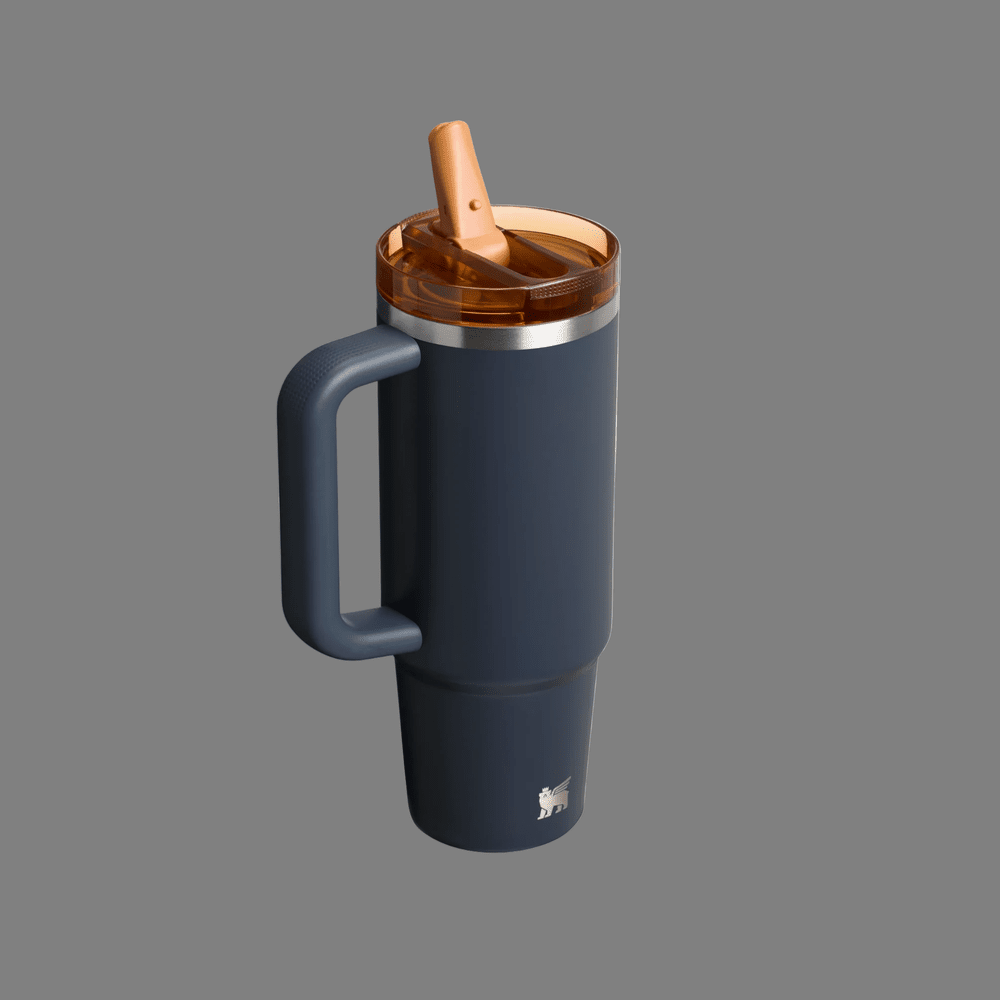 Stanley The Quencher Protour Flip Straw Tumbler 30 oz navy with orange lid, straw flipped up for sipping.
