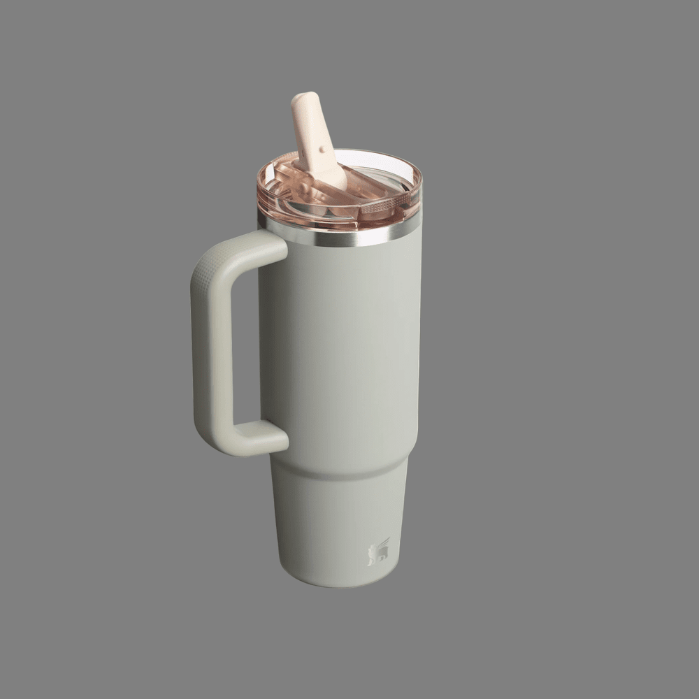 Stanley The Quencher ProTour Flip Straw Tumbler 30 oz in pale green with beige lid and handle, with the flip straw raised for sipping.