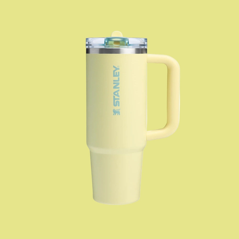 Stanley The Quencher Protour Flip Straw 30 oz pale yellow tumbler with blue logo and flip-top lid