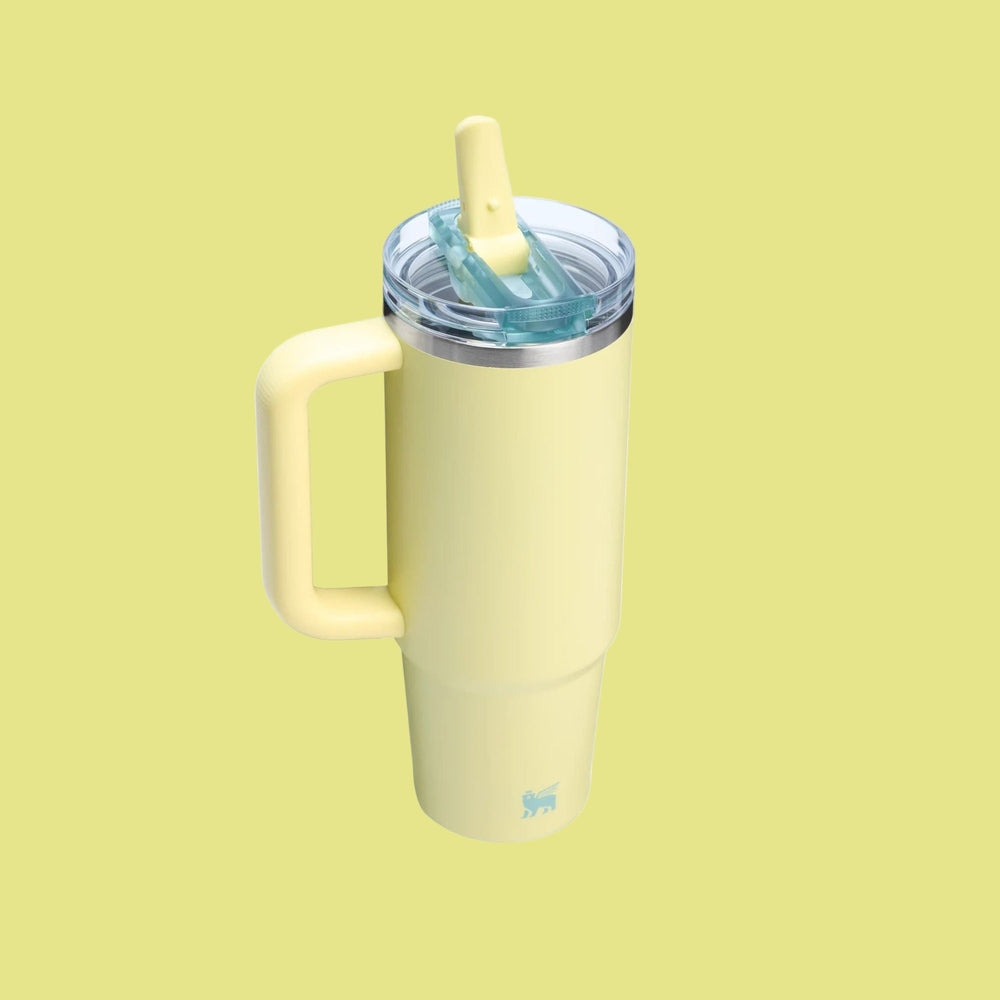 Stanley The Quencher ProTour Flip Straw Tumbler 30 oz in pale yellow with a handle, lid open and straw ready.