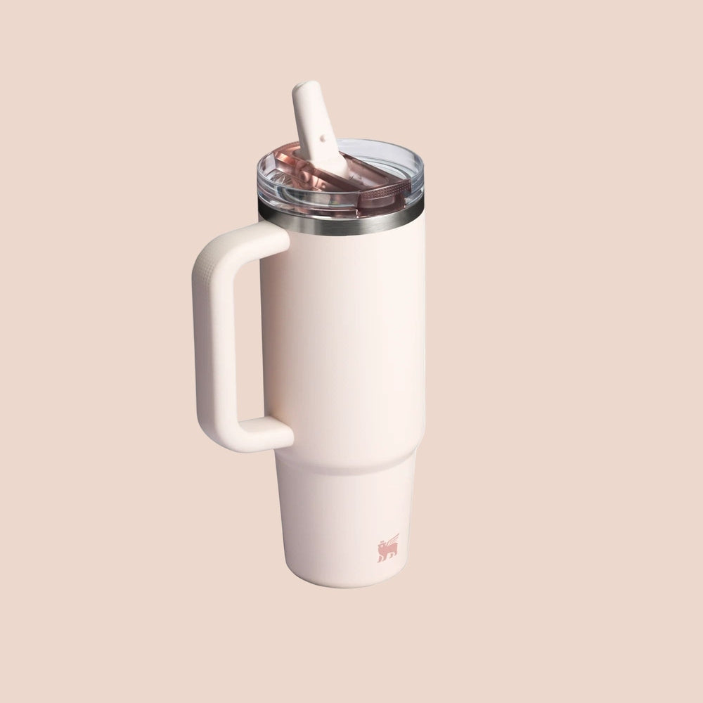 STANLEY The Quencher Protour Flip Straw Tumbler 30 oz in pale pink with a white grip handle and flip straw ready to sip.