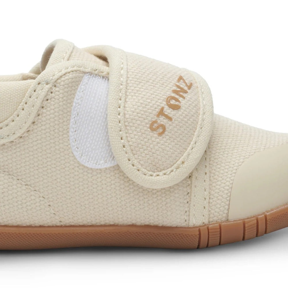 STONZ Cruiser Natural Baby Shoes Oatmeal; beige canvas with Velcro strap secured, tan rubber sole.