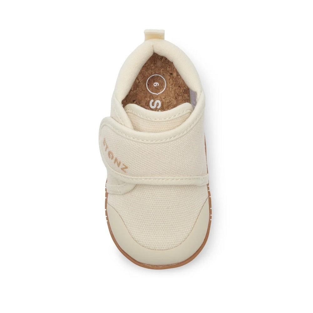 Stonz Cruiser Natural Baby Shoes Oatmeal from STONZ; cream fabric with Velcro strap, top-down view.